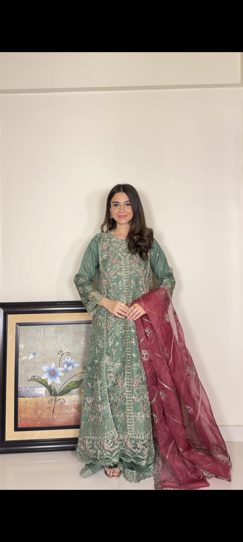 HP005 - Rich textures, intricate embroidery, and a graceful green hue combine to create a timeless gown of refined sophistication