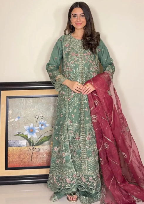 HP005 - Rich textures, intricate embroidery, and a graceful green hue combine to create a timeless gown of refined sophistication