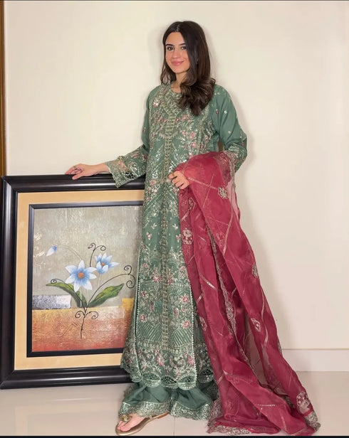 HP005 - Rich textures, intricate embroidery, and a graceful green hue combine to create a timeless gown of refined sophistication